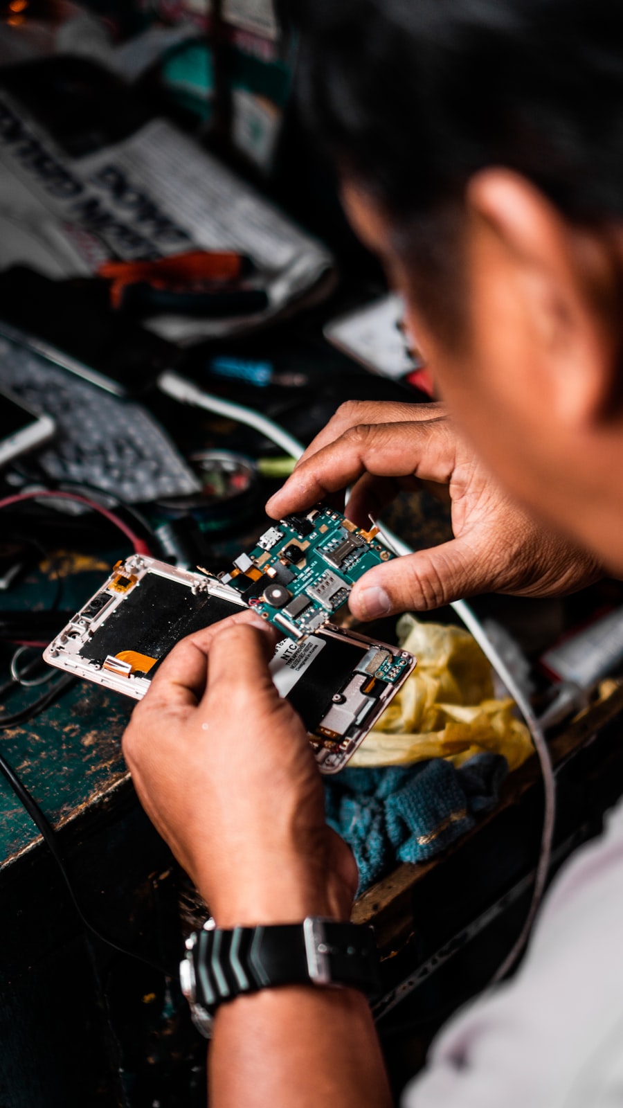 Technician repairing the internal components of a smartphone