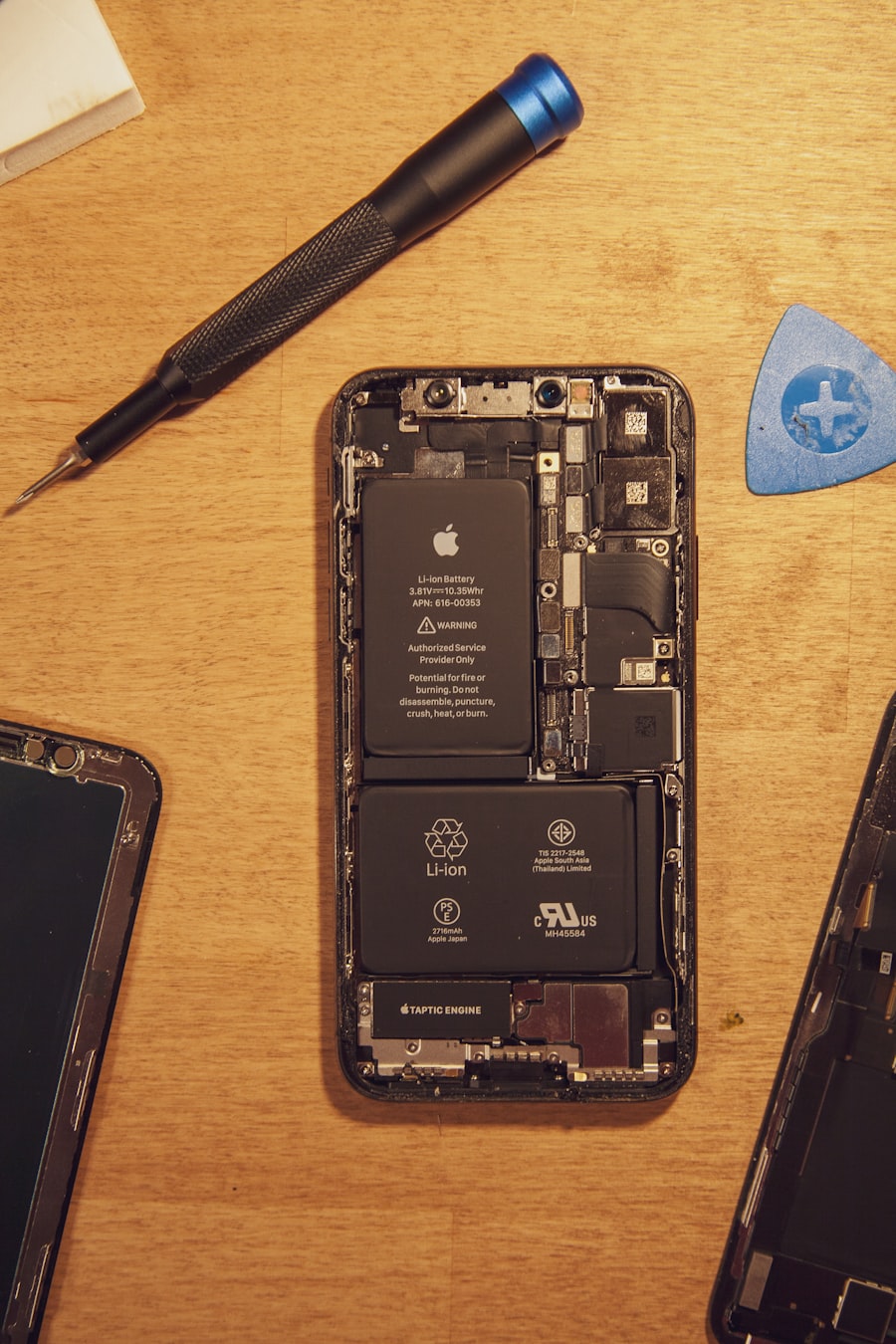 Opened smartphone beside precision repair tools